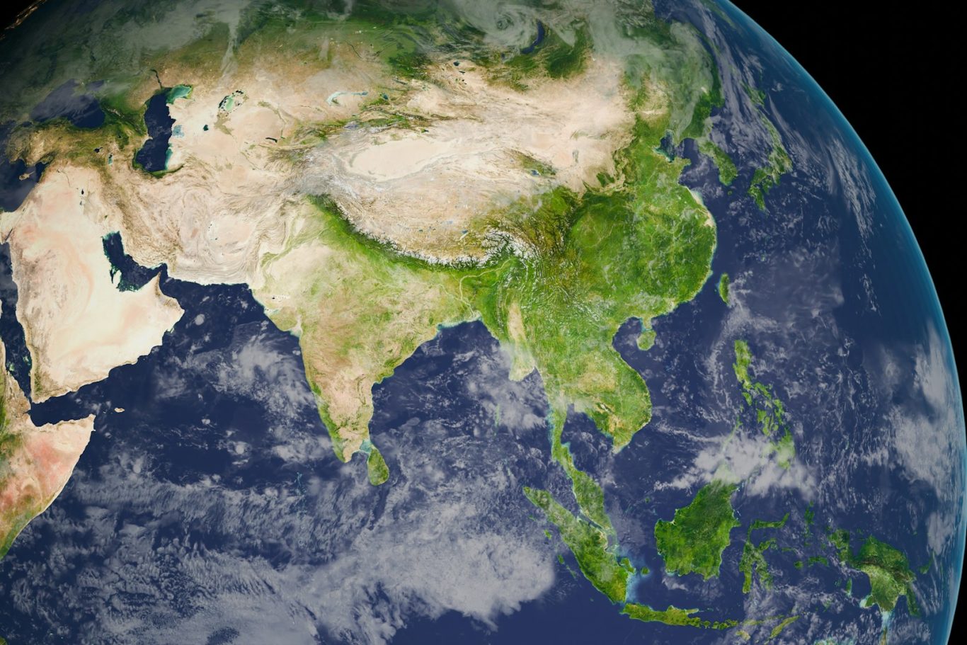Complex and evolving global rules A detailed view of Asia from space, highlighting geographical features and greenery.